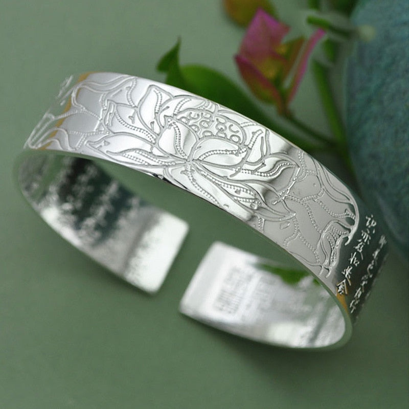 Thai silver religious jewelry for women in a silver color with a vintage, elegant lotus flower cuff bracelet that is adjustable in size.