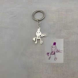 Transform your child's artwork into a precious keepsake with our customized silver creations. Simply provide us with your kid's drawing and we'll craft it into a unique silver, gold keychain, pendant, or bracelet.